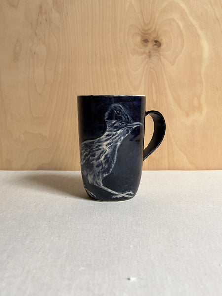 Blue mug with a realistic white road runner painted on it