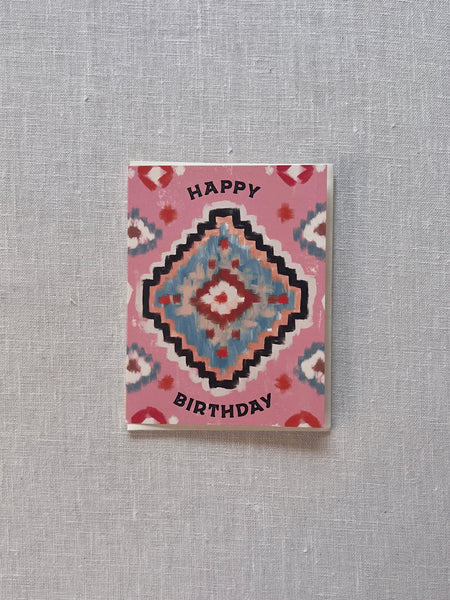 Pink card with a southwest design in blue and red with black text reading "Happy Birthday"