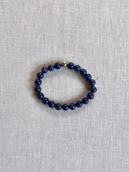 blue lapis beaded bracelet with a silver accent.