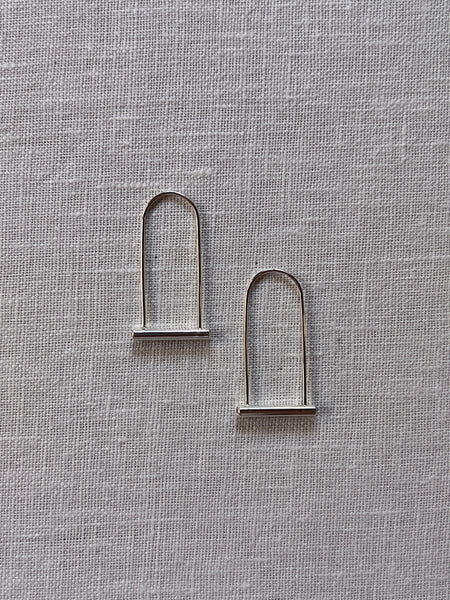 Sterling silver earrings shaped like a bike lock with Cubic Zirconia stones