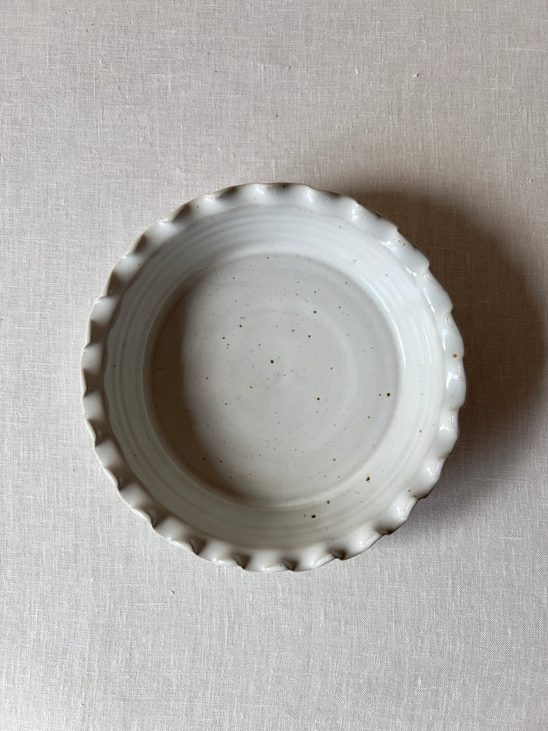 Top down view speckled white ceramic pie dish 