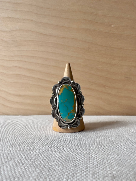 Oval turquoise ring with a wavy sterling silver casting