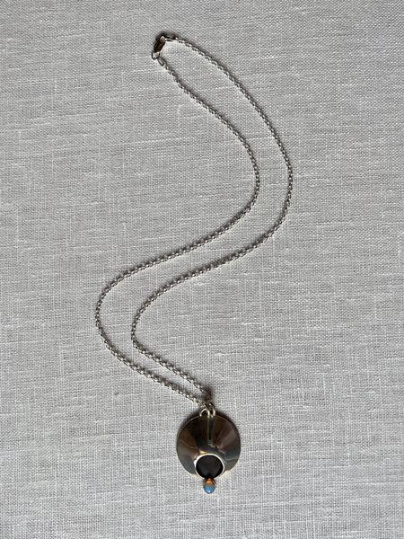sterling silver necklace with rounded half moon and an opal droplet.