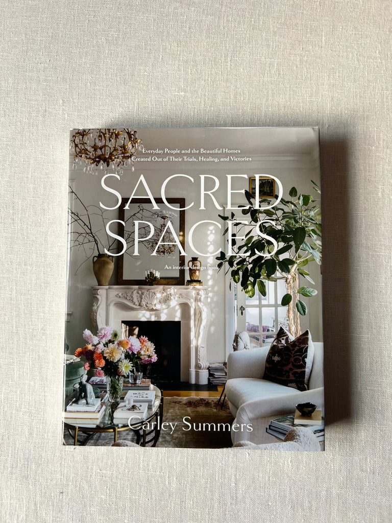 Cover of the book "Sacred Spaces" by Carley Summers . A  thoughtfully decorated home is shown on the cover