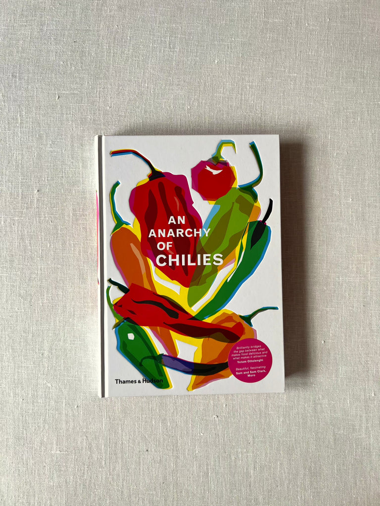 White cover of the book "An Anarchy of Chilies" with different colors of stylistic chilies 