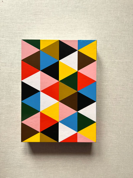 Artistic cover of book "Eames Beautiful Details" with colorful triangles