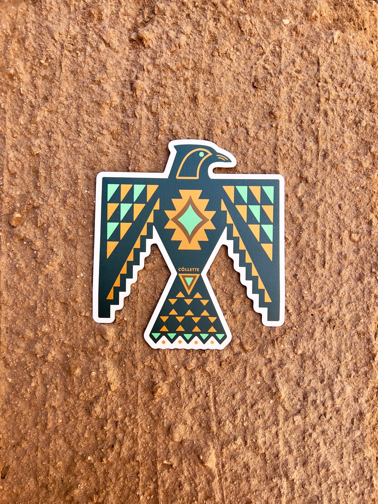Black thunderbird with yellow and turquoise triangles about its body