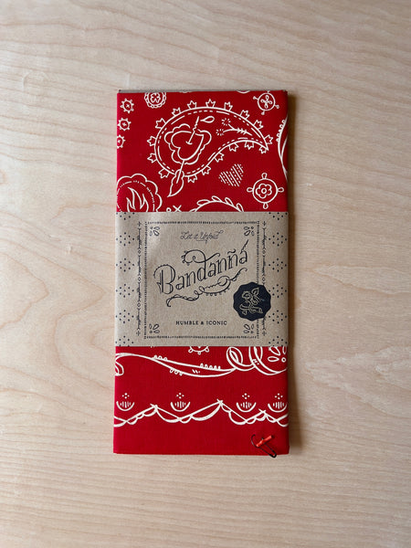 red bandanna with paisley designs, hearts and vines in off white.