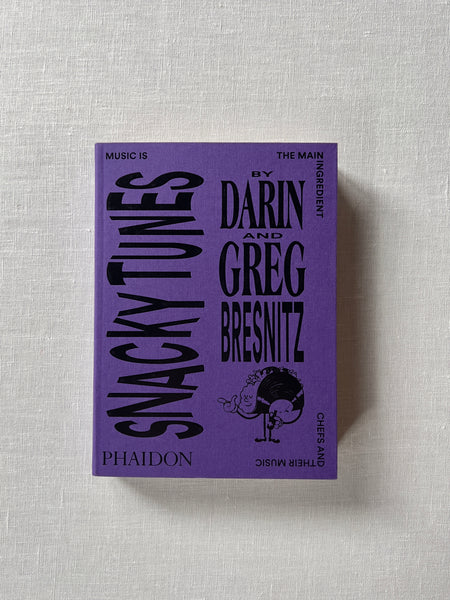 Purple cover of the book "Snacky Tunes" by Darin and Greg Bresnitz