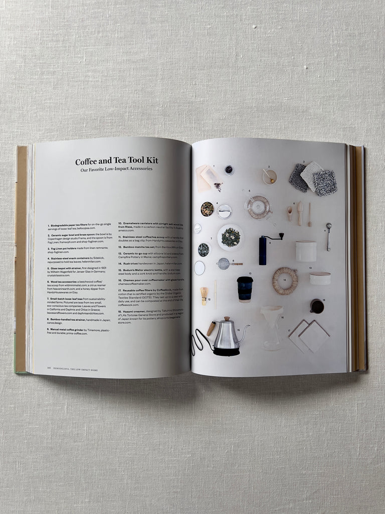 The Book "Remodelista: The Low Impact Home" opened to a page detailing a coffee and tea tool kit, coffee and tea tool are laid out on one of the two pages.