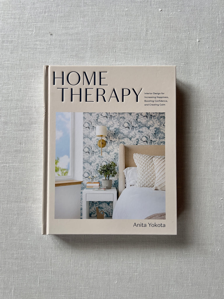 Off white cover of the book "Home Therapy" by Anita Yokota. A corner of a room is captured on the cover showing its bright design