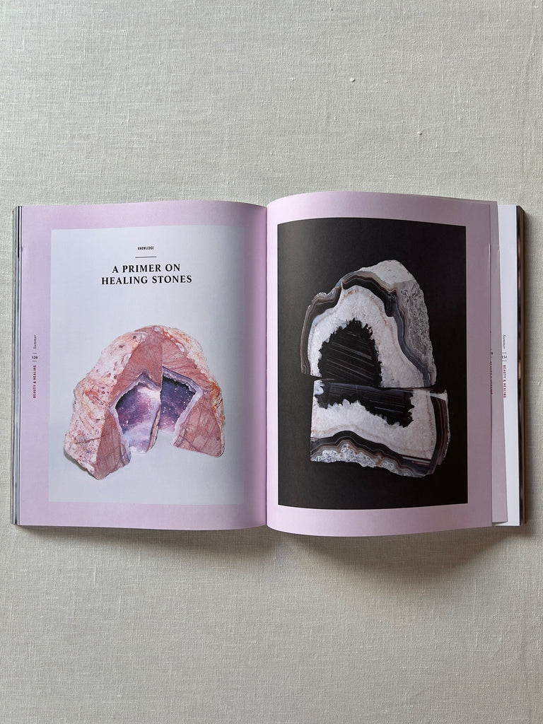 The book "a wilder life" opened to a page depicting crystals  with black text reading "A primer on healing stones."