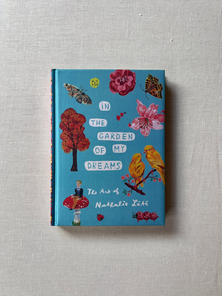 Cover of the book "In The Garden of My Dreams" with a light blue base and cutouts of various things you would see outside like flowers, trees, bugs and birds.