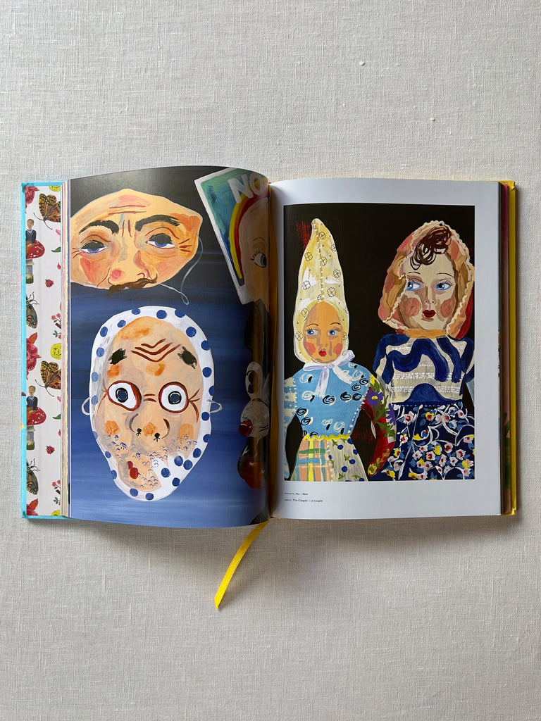 the book "In The Garden of My Dreams" opened to a page of very stylized art of many people.