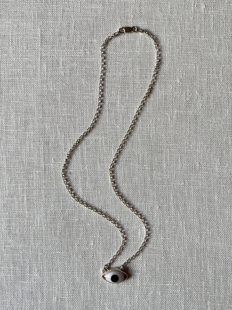 sterling silver linked chain necklace with a glass eye pendant.