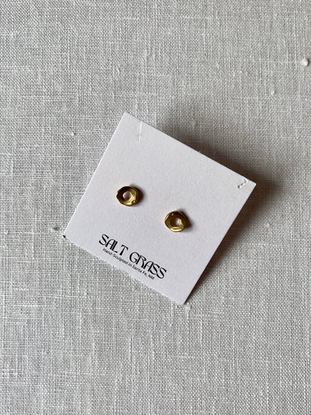 Bronze hammered studs with a donut shape.