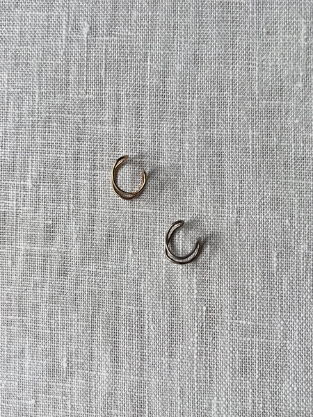 Two small ear cuffs. One gold plated (top) and the other sterling silver (bottom).