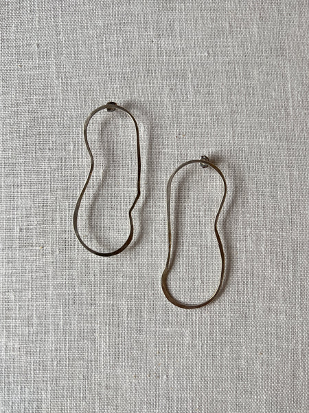 Sterling silver curvy drop earrings in the shape of a lake.