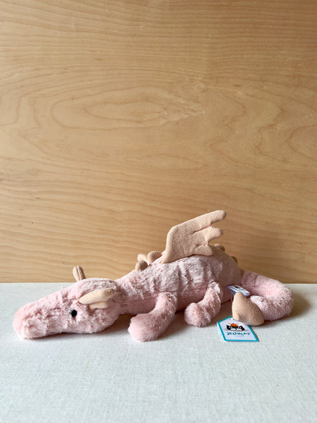 Small pink dragon plushie.