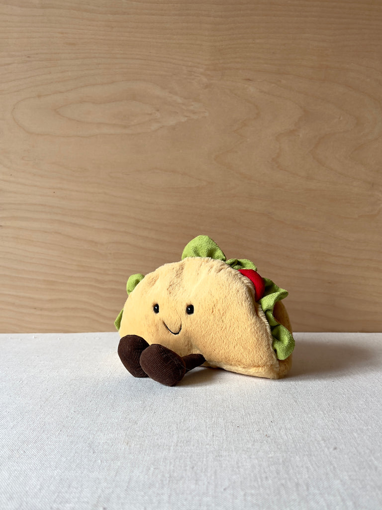 Small stuffed taco with a happy face and little feet
