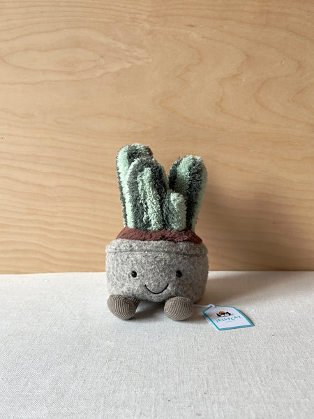 Small stuffed columnar cactus with little feet and a happyface
