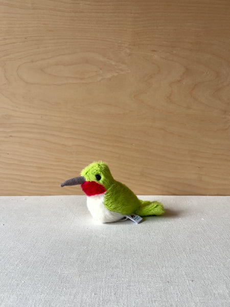 Small green, red, and white stuffed hummingbird.