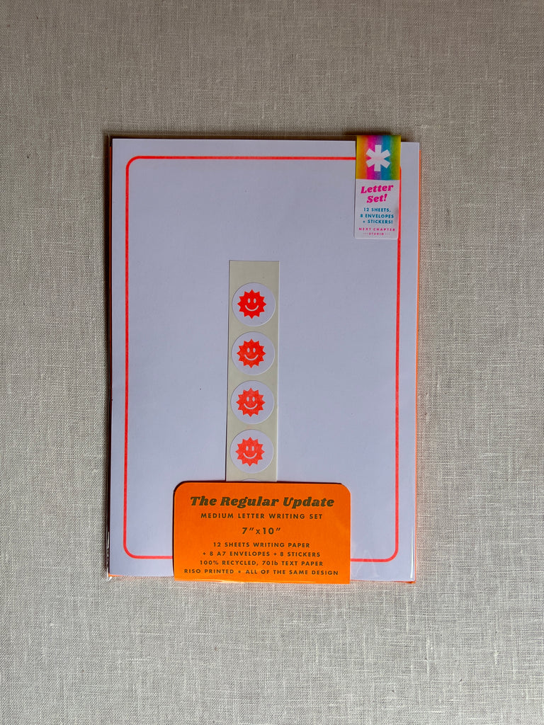 orange blank paper with a set of sun stickers in the middle