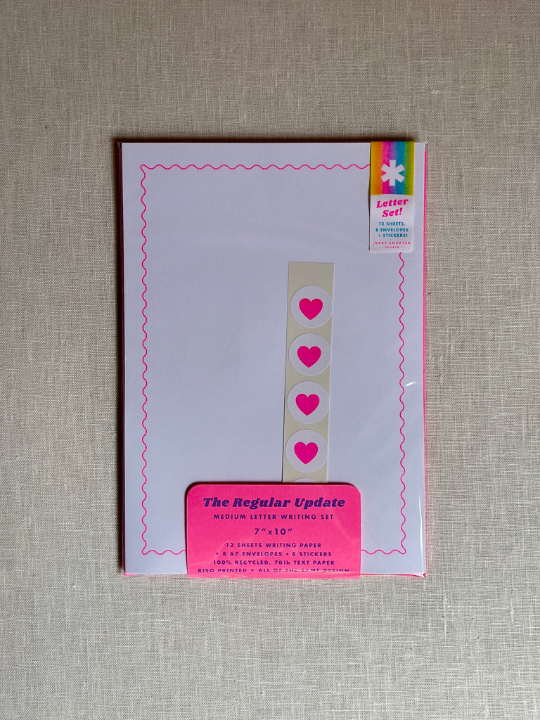 orange blank paper with a set of heart stickers in the middle