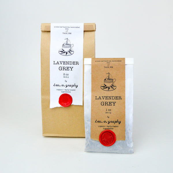  medium Brown paper Bag and a small white with a white and brown label respectively, held down by a red wax seal. both labels have black text reading "Lavender Grey"