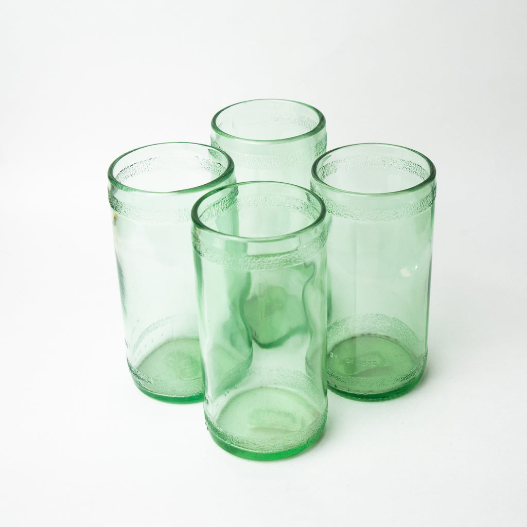 Four recycled glass cups with a textured ring around the top and bottom of the cup.