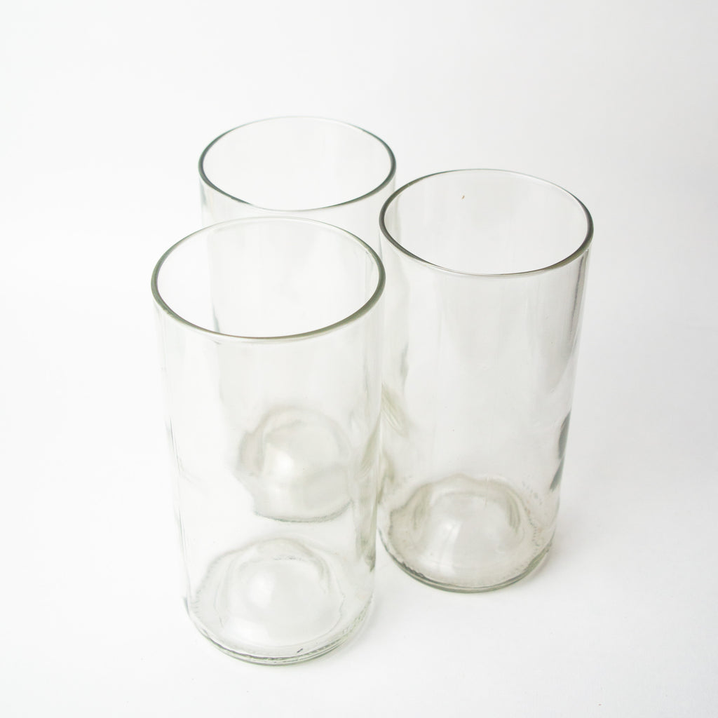 Clear drinking glass made from a recycled Gerolsteiner mineral water bottle. Size: 2.5 inches in width, 7.5 inches in height.