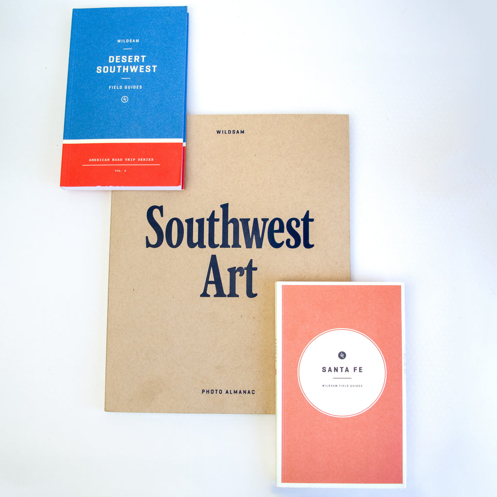 The covers of 3 seperate books titled "Desert Southwest: Field Guides, American Road Trip Series Volume 2" and "Southwest Art: Photo Almanac" and "Santa Fe: Field Guides" all by Wildsam. Each cover has colors, titles and text. No photos or images.