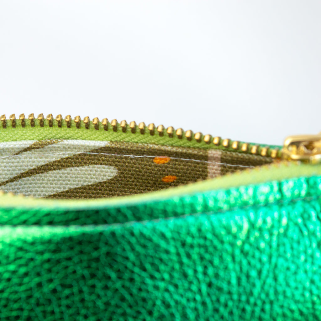 Medium metallic green pouch, opened to show the abstract print inside.
