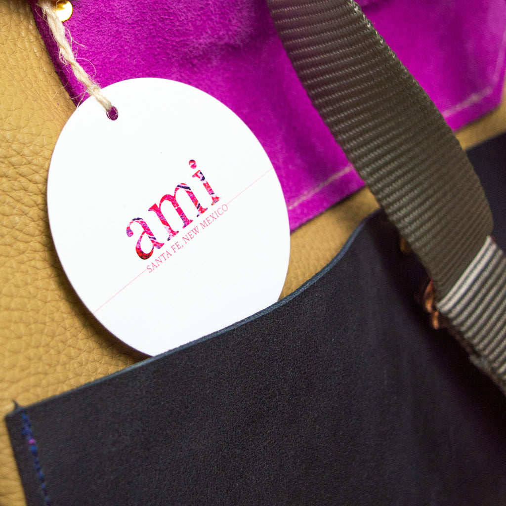 Patchwork backpack with a circular tag reading "Ami Santa Fe, New Mexico."