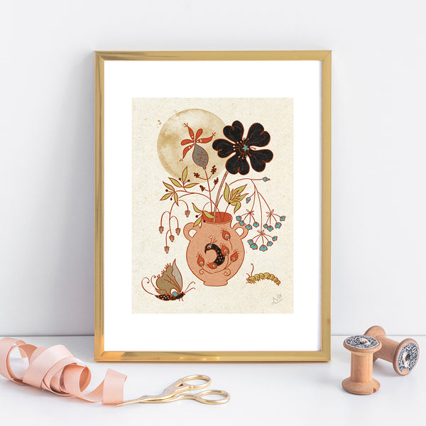 An art print in a golden frame. The art itself is a pink flower pot with a peacock head on the front, and lightly filled with different plants and flowers. Behind the flowers is the moon. In the foreground of the print, there is a butterfly to the left and a caterpillar to the right. The art is stylized with a mostly neutral color palette. There are pops of colors in the flowers and bugs.