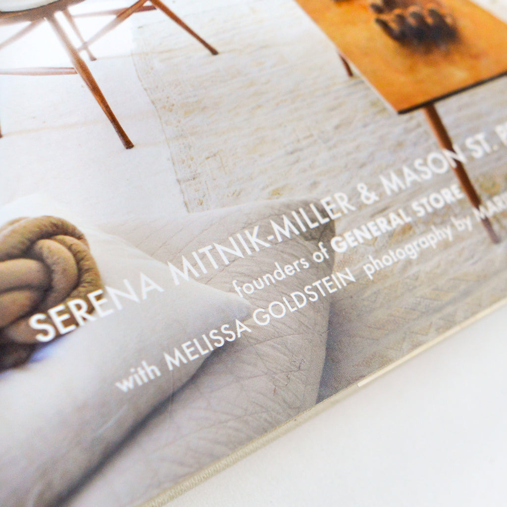 Close up picture of the bottom of the Abode book, focusing on lettering reading "Serena Mitnik-Miller & Mason ST. ... Founders of General Store ... with Melissa Goldstein Photography by Mar ..." ellipsis are to represent the lettering being cut off by the photo framing in the right most corner