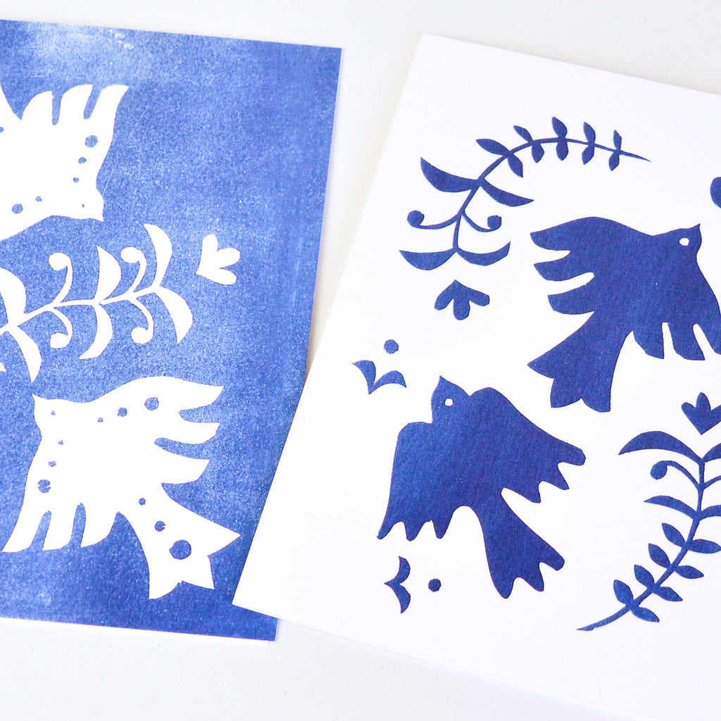 One blue card and one white card, both with two doves and an olive leaf.
