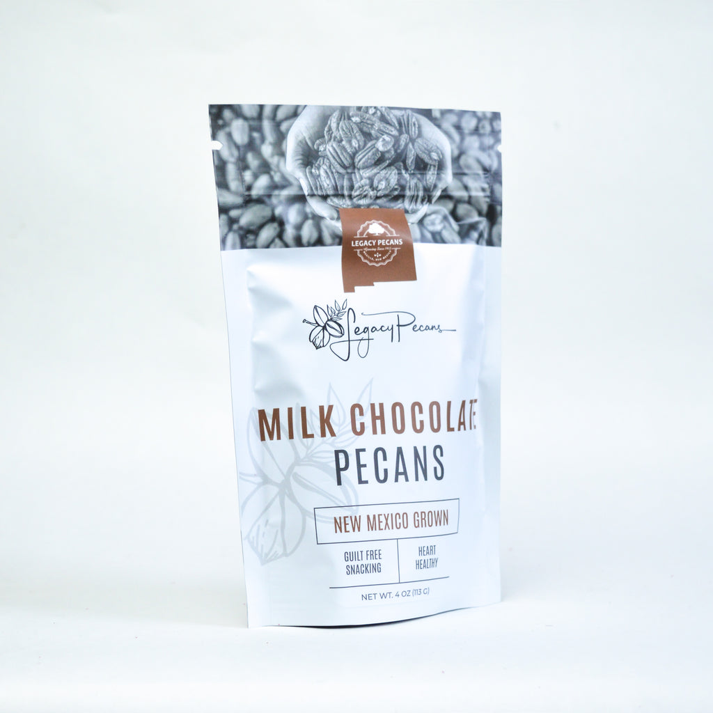 A bag of milk chocolate pecans on a white backdrop.