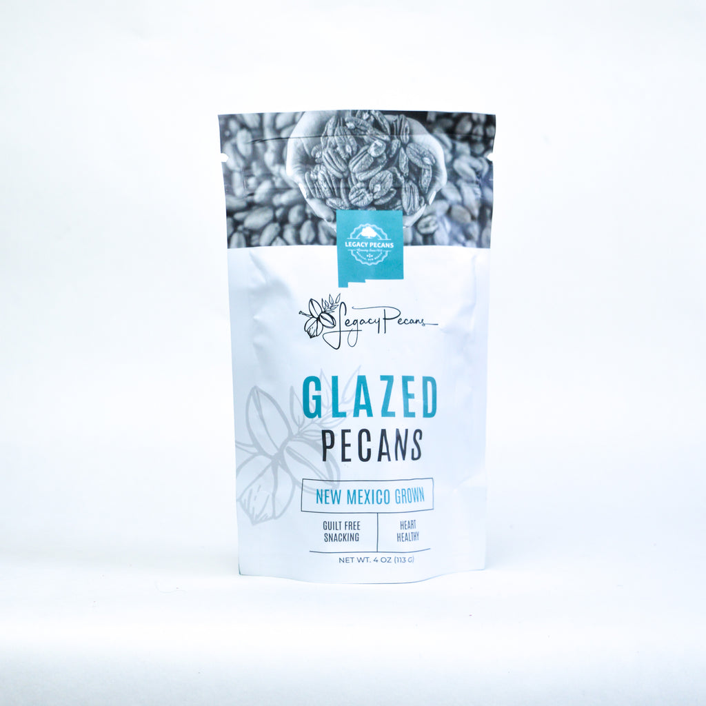 A bag of glazed pecans on a white backdrop.