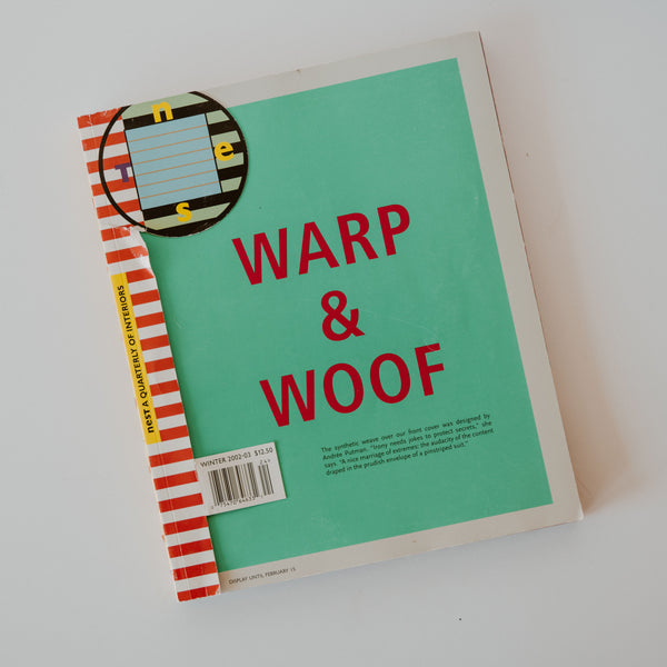 The cover of a vintage magazine "Warp & Woof" published by Nest. The cover is turquoise with red and white strips on the binding and red text. Additional text reads "The synthetic weave over our front cover was designed by Andrée Putman." "Irony needs jokes to protect secrets, she says." "A nice marriage of extremes: the audacity of the content draped in the prudish envelope of a pinstriped suit."