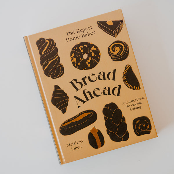 Cover of the book "Bread Ahead" by Matthew Jones which has a tan base and various pastries in a dark brown color. There is other text on the book reading "the expert home baker" "a masterclass in classic baking."