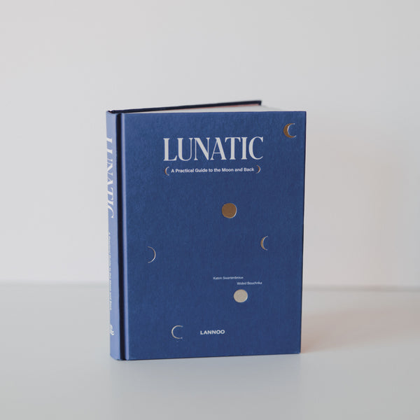 A cover of the book "Lunatic" by Katrin Swartenbroux and Wided Bouchrika. The cover is blue with text and illustrations of different phases of the moon. Additional text reads "A Practical Guide to the Moon and Back."