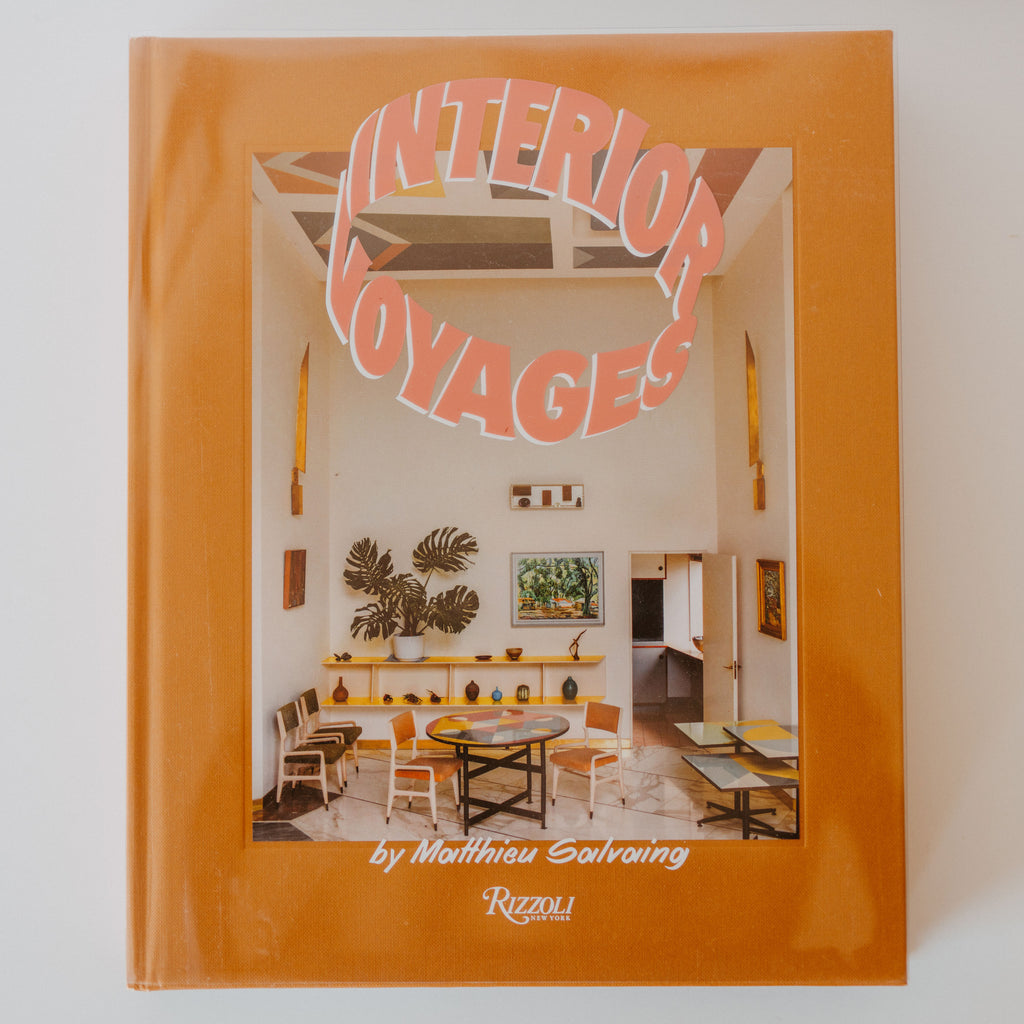 Cover of book "Interior Voyage" by Mattheu Salvaing. a small room with various furniture is depicted on the cover.