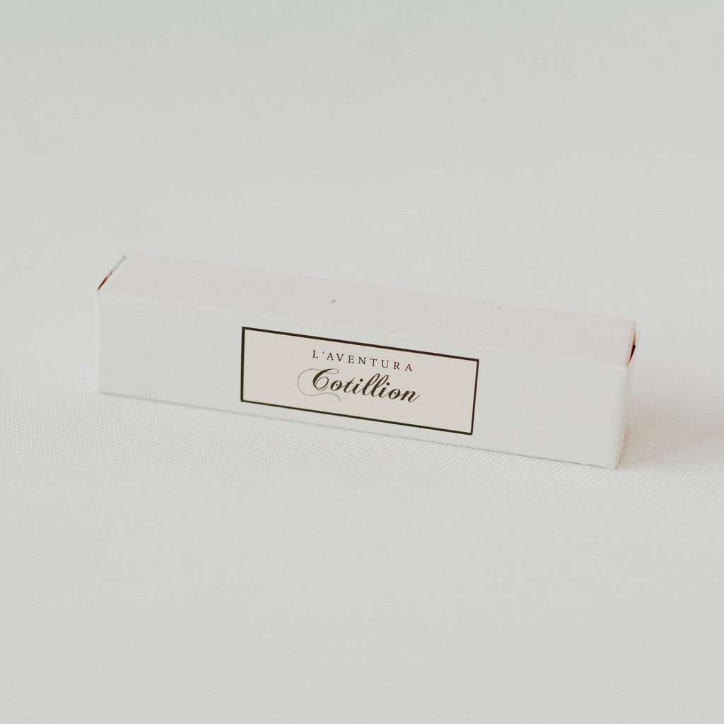 White rectangular cardboard box with a white label and black text that reads "l'aventura cotillion."