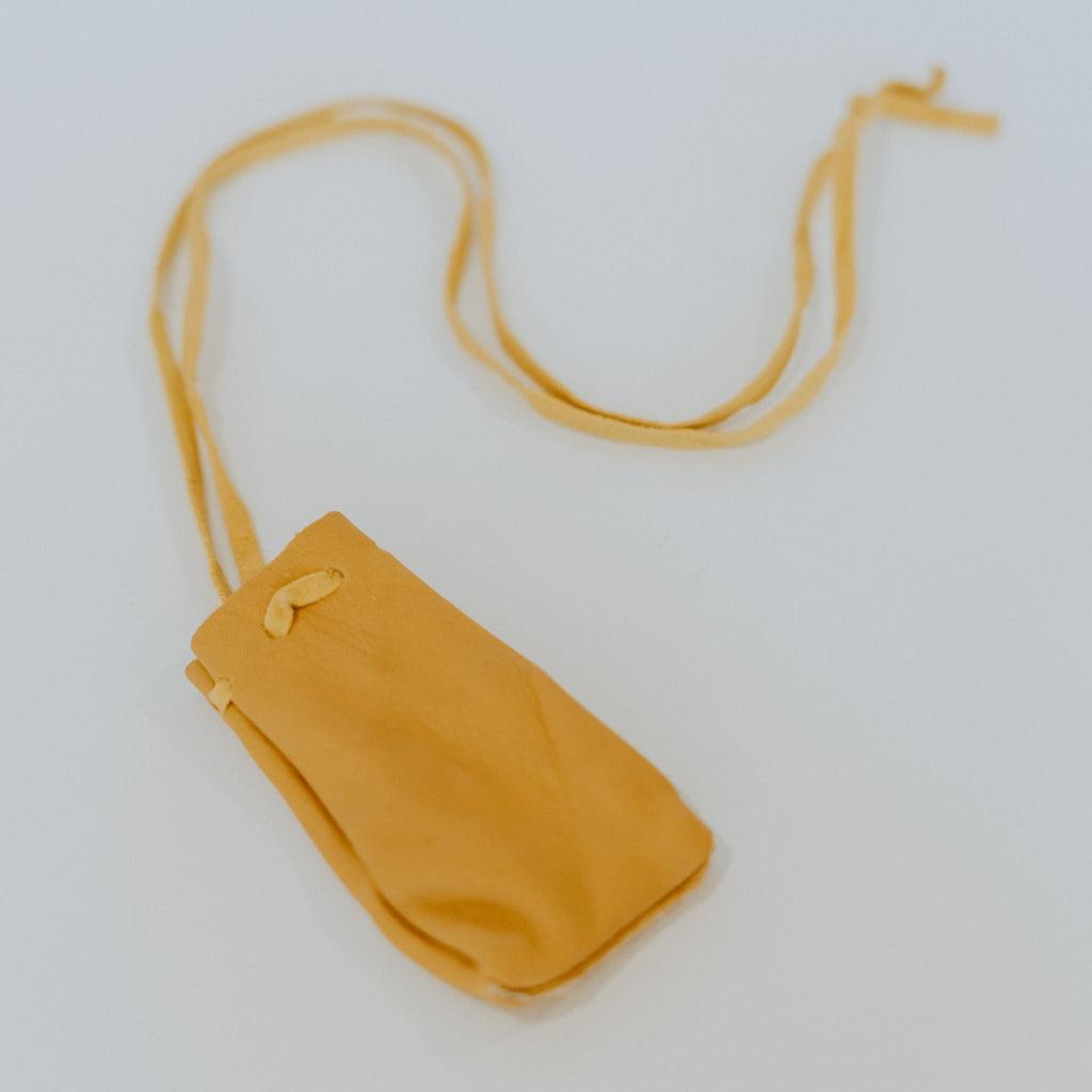 Yellow soft leather bag with a long leather strap.