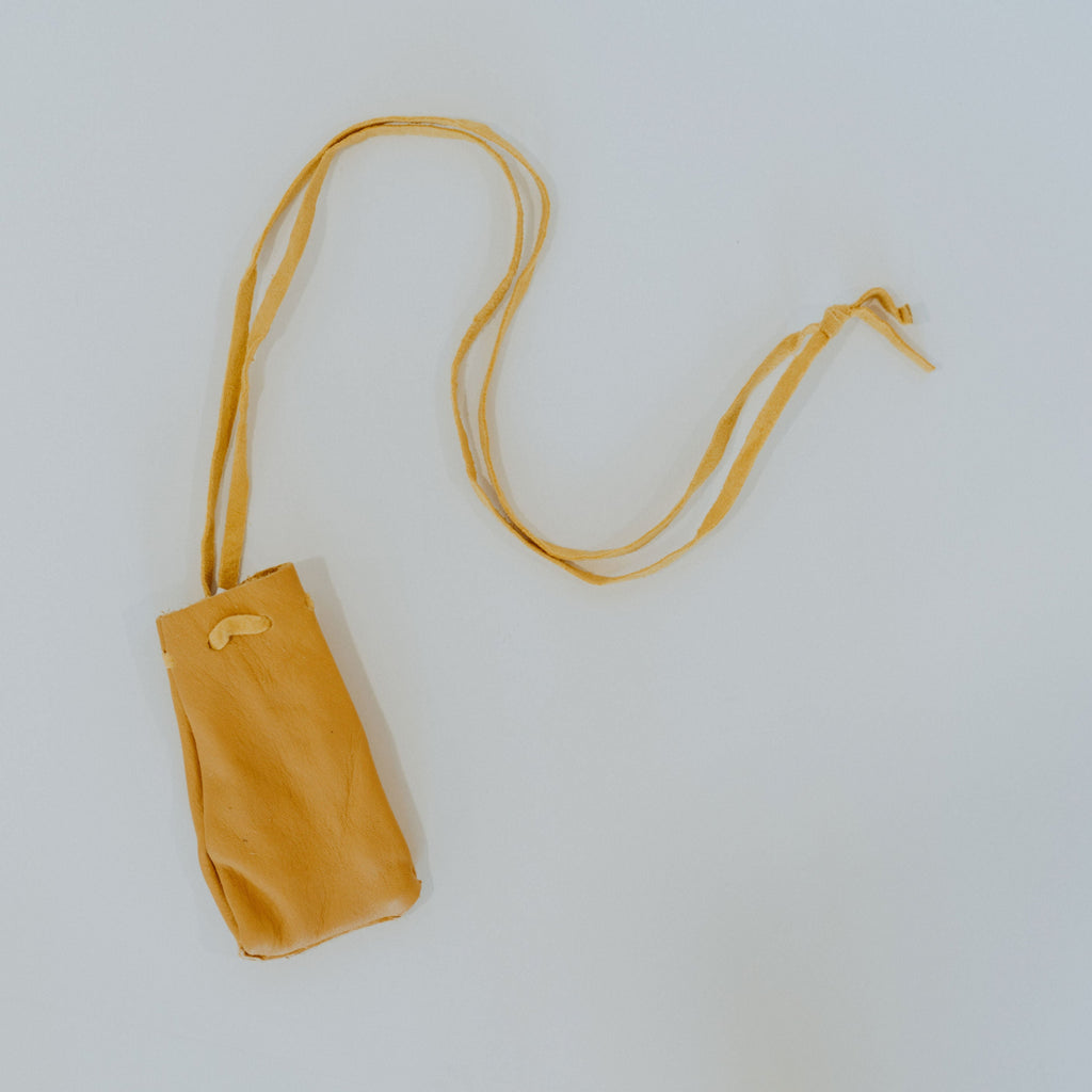Yellow soft leather bag with a long leather strap.