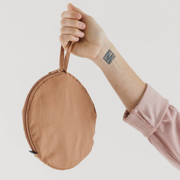 Circular tan bag with thin handle