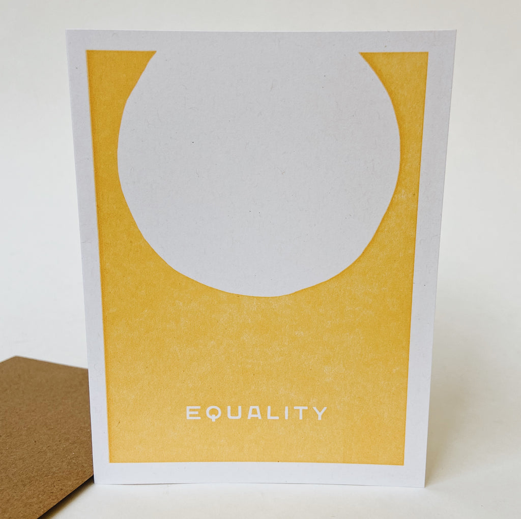 White card that has a yellow block on it with a white sphere and the word equality on the bottom center.