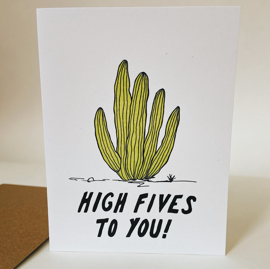 White card with a green cactus which has five branches. Below the cactus is black text reading "high fives to you!"