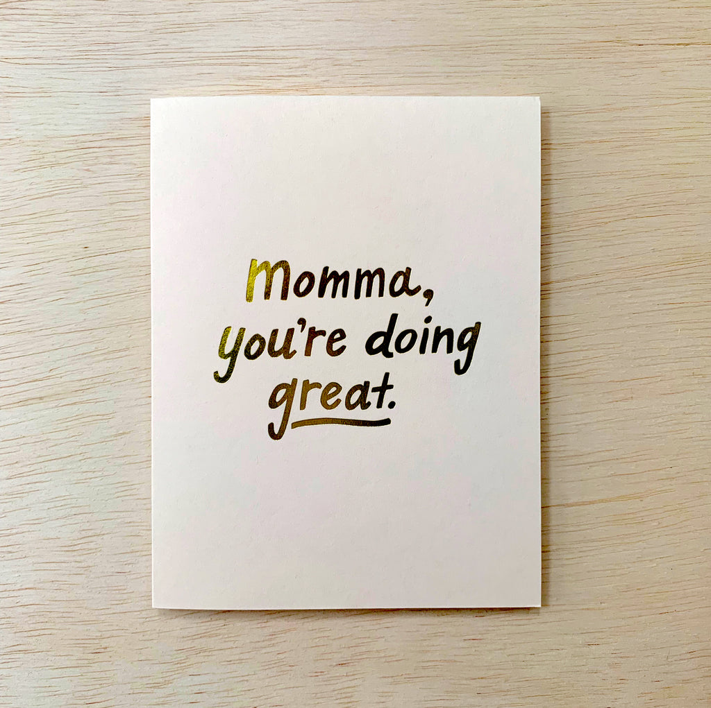 White card with golden text reading "Momma, you're doing great."